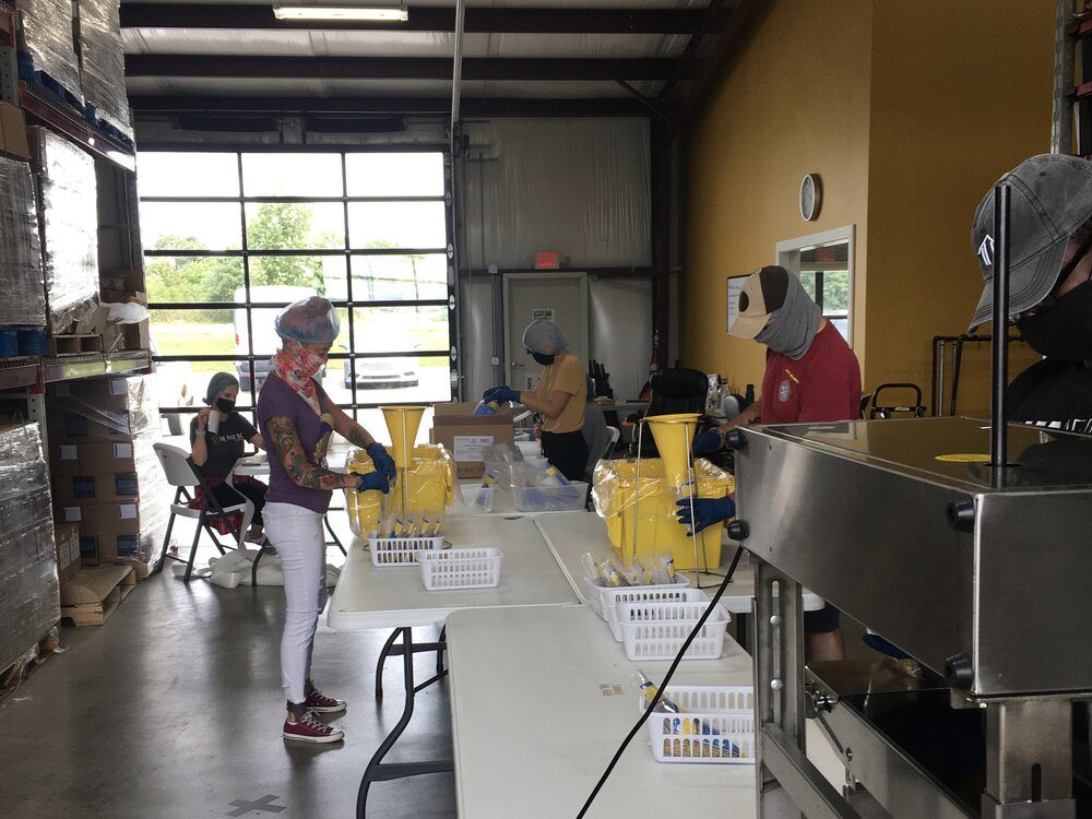 Displaced hospitality workers pack meals for food insecure community members as part of Get Shift Done for Northwest Arkansas .